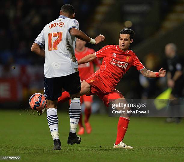 Philippe Coutinho of Liverpool competes with Liam Trotter of Bolton Wanderers during the FA Cup Fourth Round Replay match between Bolton Wanderers...