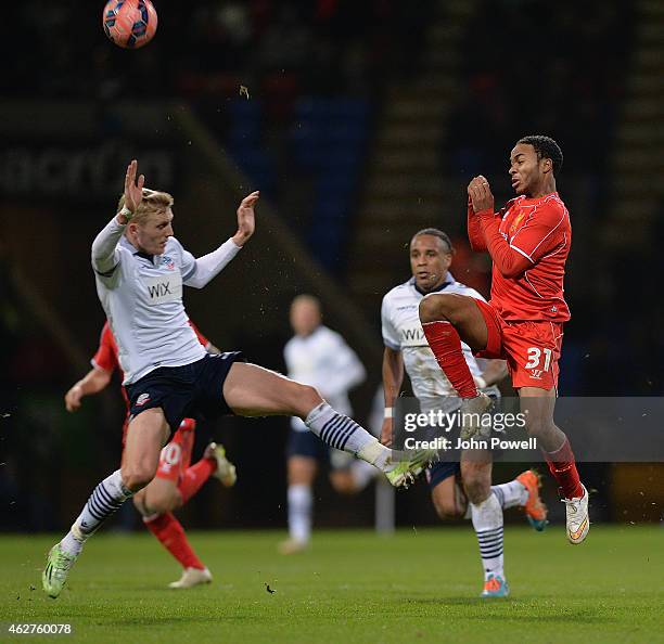 Raheem Sterling of Liverpool competes with Tim Ream of Bolton Wanderers during the FA Cup Fourth Round Replay match between Bolton Wanderers and...