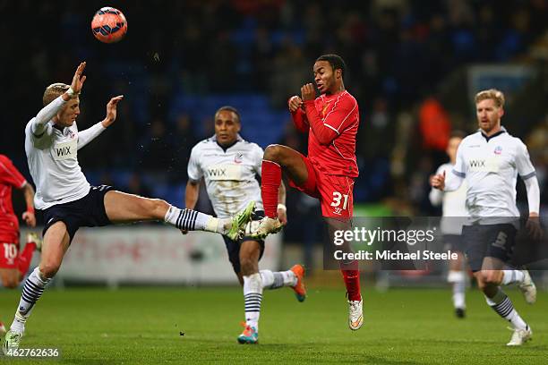 Raheem Sterling of Liverpool challenges Dean Moxey of Bolton during the FA Cup fourth round replay match between Bolton Wanderers and Liverpool at...