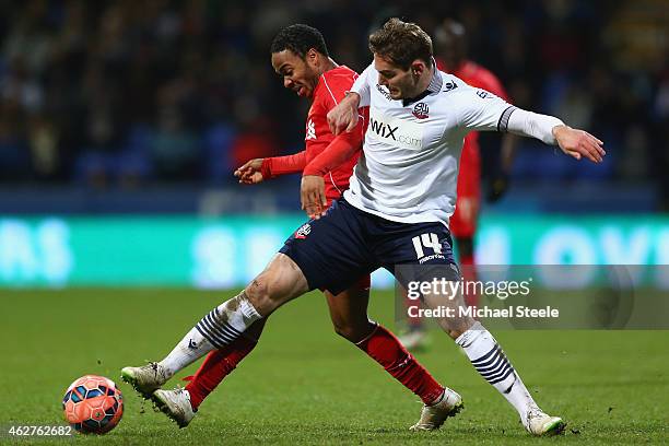 Dorian Dervite of Bolton challenges Raheem Sterling of Liverpool during the FA Cup fourth round replay match between Bolton Wanderers and Liverpool...
