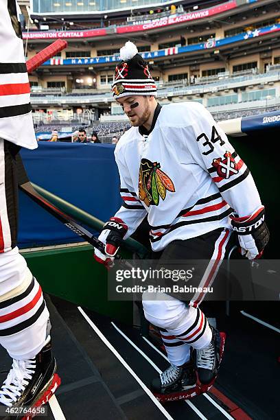 Tim Erixon of the Chicago Blackhawks makes his way out of the locker room toward the ice surface for practice prior to the 2015 Bridgestone NHL...