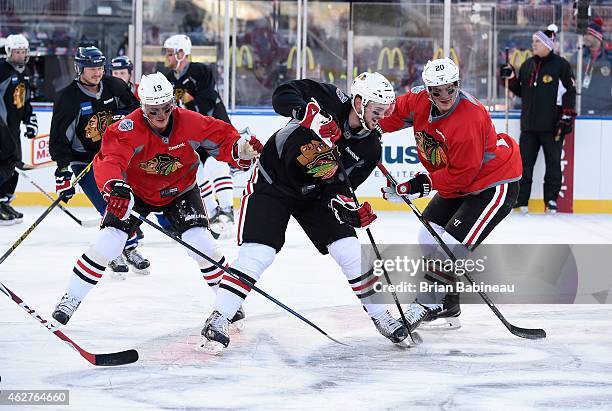 Jonathan Toews, Tim Erixon and Brandon Saad of the Chicago Blackhawks skate during practice day prior to the 2015 Bridgestone NHL Winter Classic on...