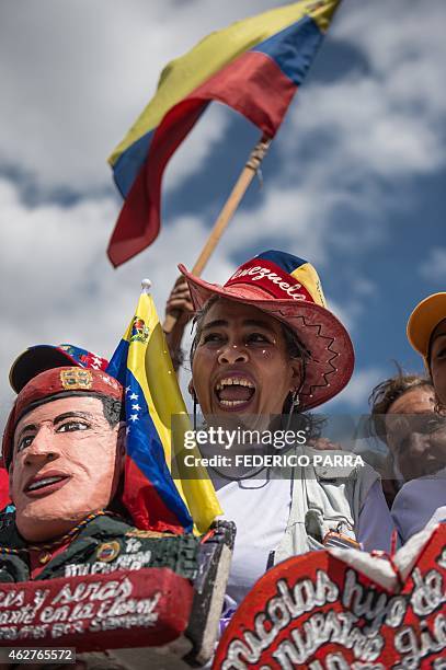 Supporters of Venezuelan President Nicolas Maduro cheer during the a military parade to commemorate the 23rd anniversary of former Venezuelan...