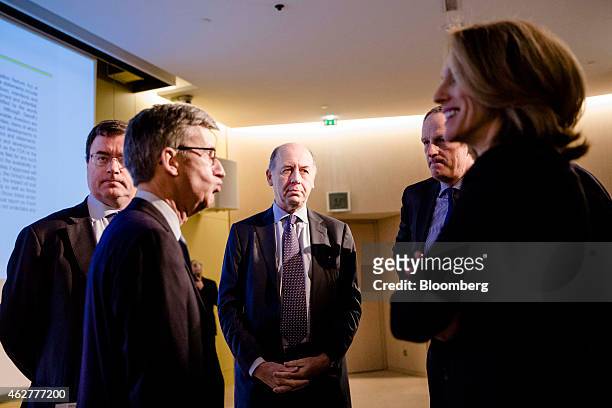 Serge Weinberg, chairman and interim chief executive officer of Sanofi, center, stands with, left to right, Olivier Charmeil, president of Sanofi's...