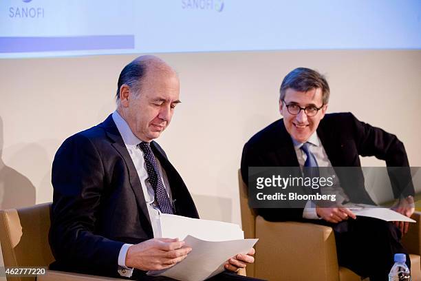 Serge Weinberg, chairman and interim chief executive officer of Sanofi, left, sits beside Jerome Contamine, chief financial officer of Sanofi, during...