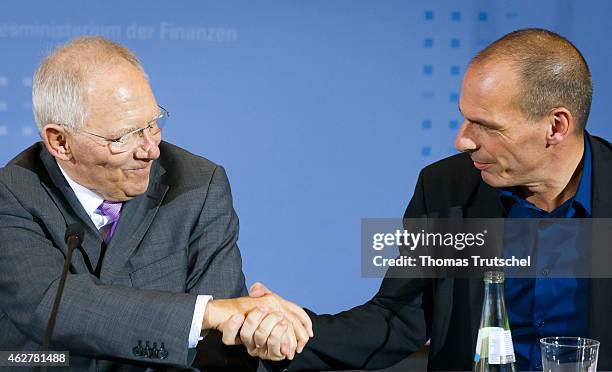 New Greek Finance Minister Yanis Varoufakis and German Finance Minister Wolfgang Schaeuble shake hands after a press conference on February 05, 2014...