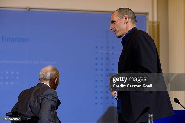 New Greek Finance Minister Yanis Varoufakis and German Finance Minister Wolfgang Schaeuble leave a press conference following talks on February 5,...