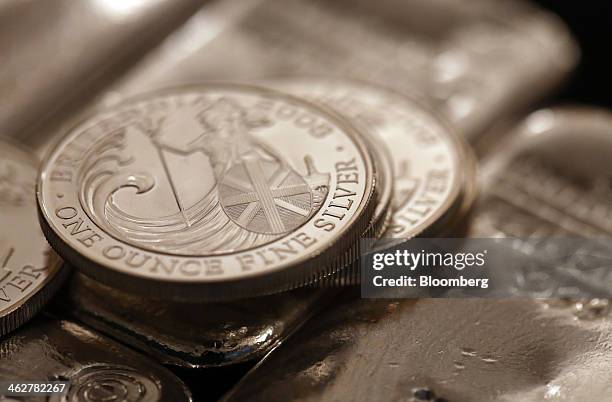 British one ounce silver coins sit on one kilogram silver bars in this arranged photograph at Gold Investments Ltd. Bullion dealers in London, U.K.,...