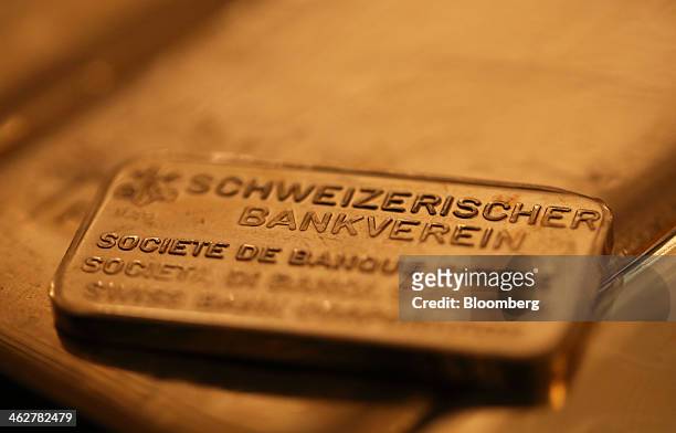 Branded one hundred gram gold bar is seen in this arranged photograph at Gold Investments Ltd. Bullion dealers in London, U.K., on Wednesday, Jan....