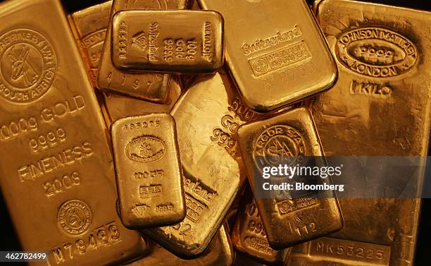 Multiple weighted gold bars sit in a stack in this arranged photograph at Gold Investments Ltd. Bullion dealers in London, U.K., on Wednesday, Jan....