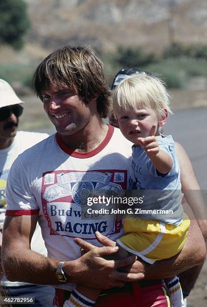 Portrait of media personality and Olympic Decathlon gold medalist Bruce Jenner holding his son Burt at a go-kart race during photo shoot. Malibu, CA...