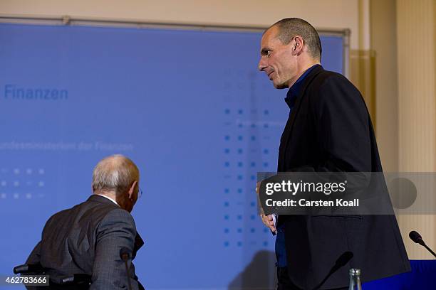 New Greek Finance Minister Yanis Varoufakis and German Finance Minister Wolfgang Schaeuble leave a press conference following talks on February 5,...