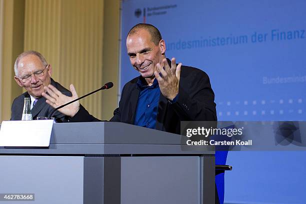New Greek Finance Minister Yanis Varoufakis getures while he and German Finance Minister Wolfgang Schaeuble speak to the media following talks on...