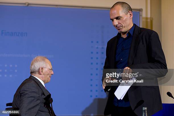 New Greek Finance Minister Yanis Varoufakis and German Finance Minister Wolfgang Schaeuble leave a press conference following talks on February 5,...