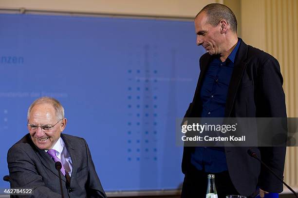 New Greek Finance Minister Yanis Varoufakis and German Finance Minister Wolfgang Schaeuble leave a press conference following talks on February 5,...