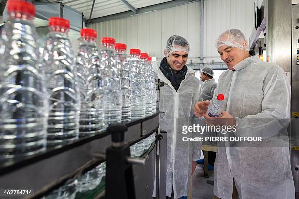 French former minister between 2002 and 2007 Renaud Dutreil visit the Fontaine Jolival factory in Vuil-et-Giget, southwestern France, with...
