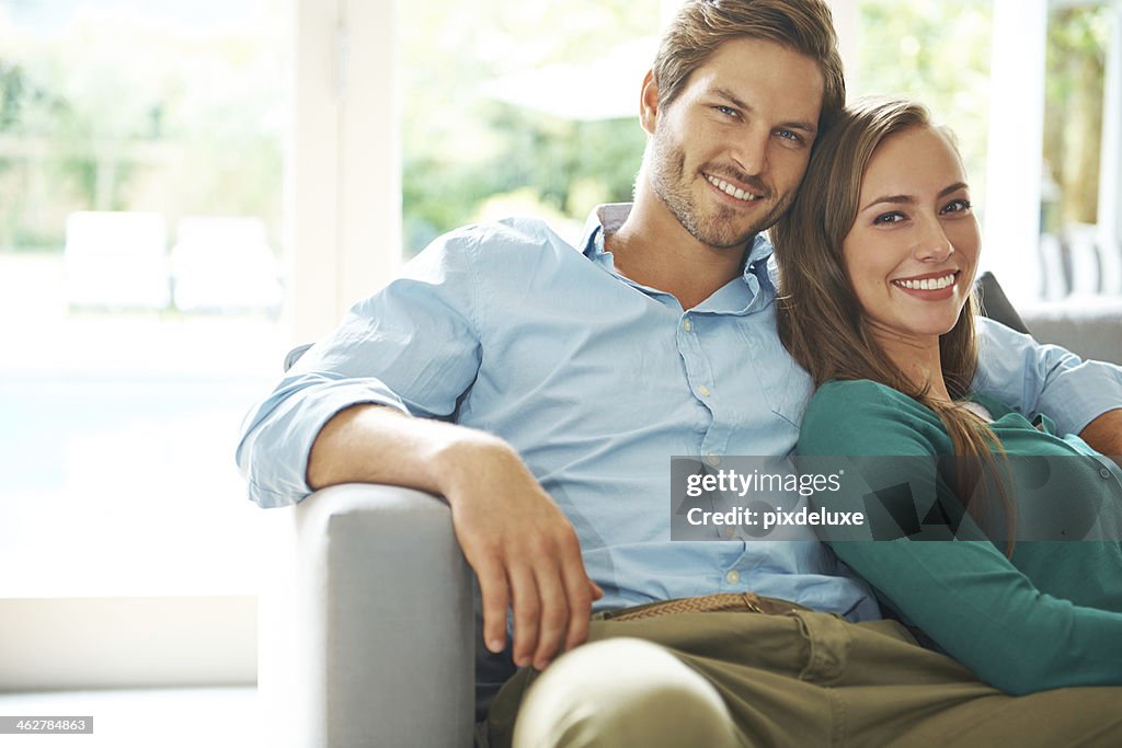 Smiling young couple relaxing on couch