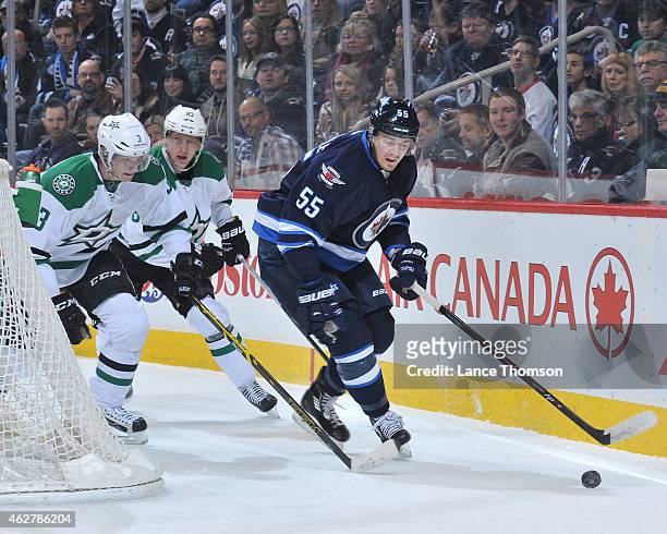 Mark Scheifele of the Winnipeg Jets plays the puck behind the net away from John Klingberg and Ales Hemsky of the Dallas Stars during first period...