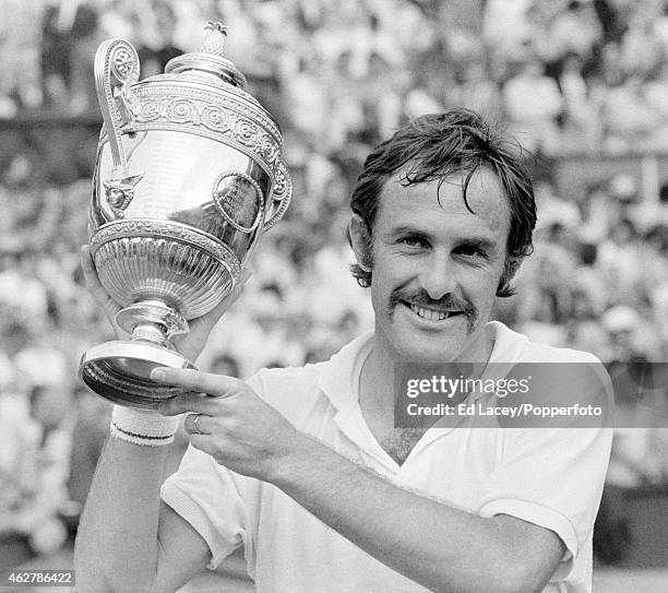 John Newcombe of Australia holding the Wimbledon trophy after winning the Men's Single final, defeating Stan Smith of the United States in five sets...