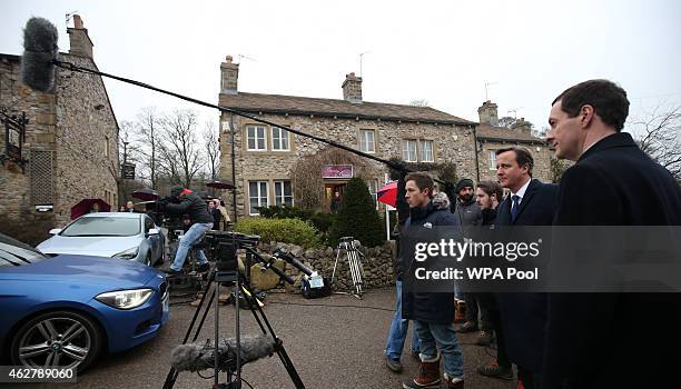 Chancellor Of The Exchequer George Osborne and Prime Minister David Cameron watch a scene being filmed on the set of television series Emmerdale on...