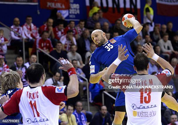 Serbia's pivot Alem Toskic and left back Momir Ilic react as Russia's right back Konstantin Igropulo jumps to score during the men's EHF Euro 2014...