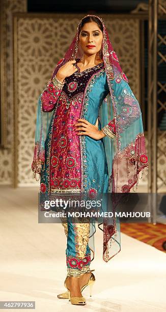 Model presents a creation by designer Hana al-Oheibeh during a fashion show organised as part ot the Muscat Festival on February 5, 2015 in the Omani...