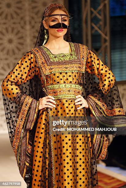 Model presents a creation by designer Hana al-Oheibeh during a fashion show organised as part ot the Muscat Festival on February 5, 2015 in the Omani...