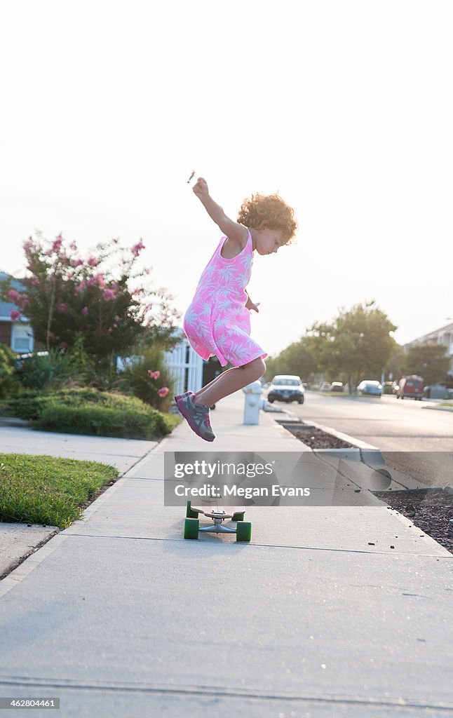 Girl jumping on skateboard