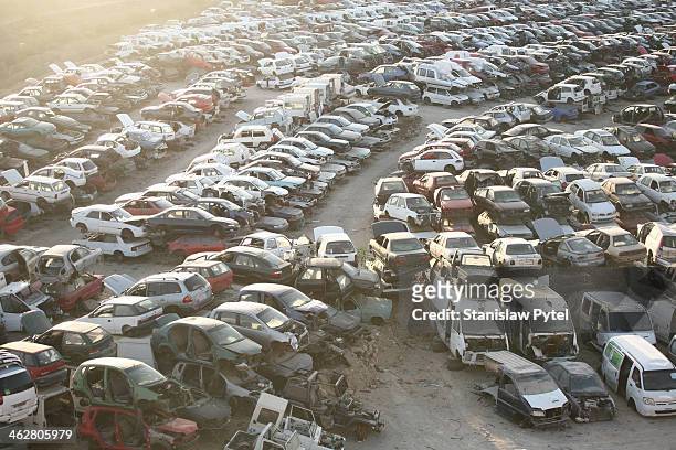 scrap-heap full of cars, top view, sunset - autoschrottplatz stock-fotos und bilder