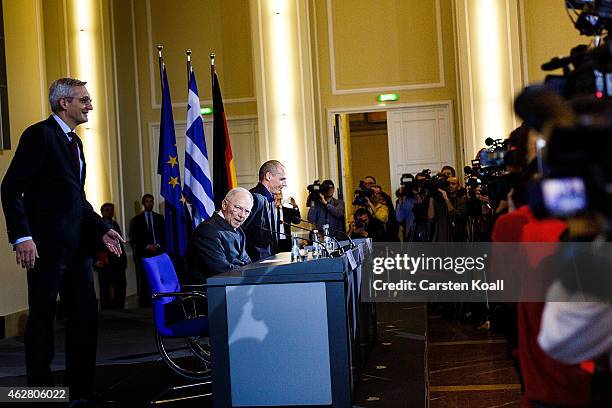 New Greek Finance Minister Yanis Varoufakis and German Finance Minister Wolfgang Schaeuble arrive to speak to the media following talks on February...