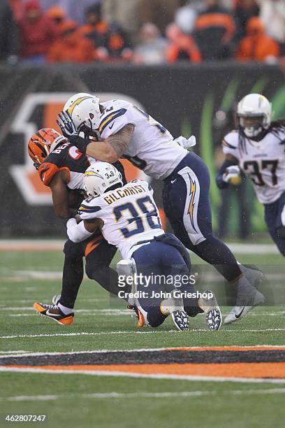 Giovani Bernard of the Cincinnati Bengals is tackled by Manti Te'o and Marcus Gilchrist of the San Diego Chargers during their AFC Wild Card playoff...