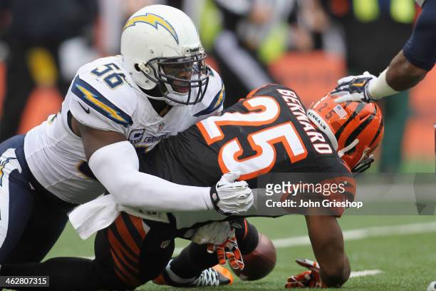 Giovani Bernard of the Cincinnati Bengals fumbles the football after being hit by Donald Butler of the San Diego Chargers during their AFC Wild Card...