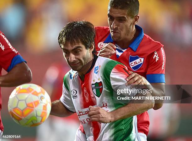 Palestino from Chile's footballer Diego Rosende vies for the ball with Nicolas Prieto of Nacional of Uruguay during their Copa Libertadores 2015 at...