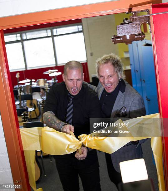 Carter Lay and Matt Sorum cut the ribbon at the Adopt the Arts Ribbon-Cutting Ceremony at Westminster Elementary School on February 5, 2015 in...