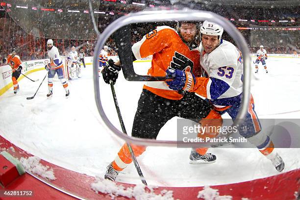 Casey Cizikas of the New York Islanders and Jakub Voracek of the Philadelphia Flyers battle for the pick in the second period at Wells Fargo Center...