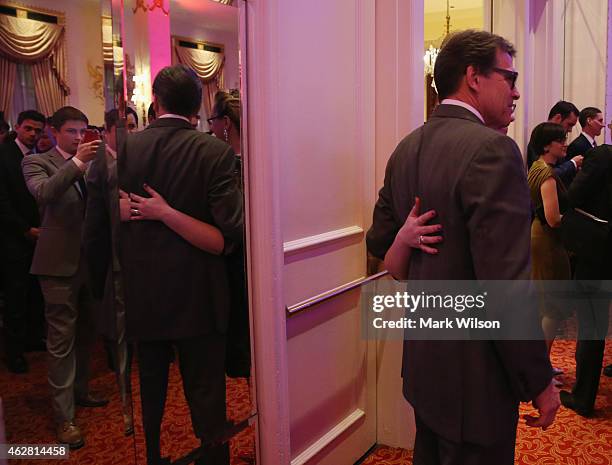 Former Texas governor Rick Perry poses for pictures with supporters at the American Principles Projects Red, White and Blue Gala at the Mayflower...