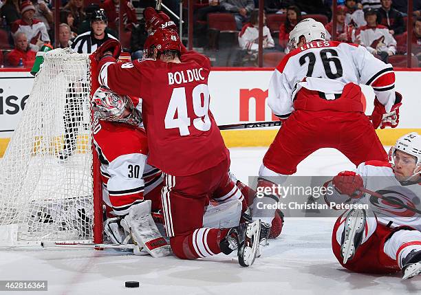 Alexandre Bolduc of the Arizona Coyotes is penalized for goaltender interference on Cam Ward of the Carolina Hurricanes during the first period of...