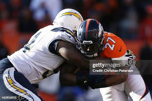 Corey Liuget of the San Diego Chargers tackles Knowshon Moreno of the Denver Broncos during the AFC Divisional Playoff Game at Sports Authority Field...