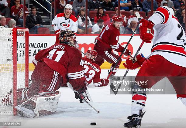 Goaltender Mike Smith of the Arizona Coyotes makes a pad save on a shot from Justin Faulk of the Carolina Hurricanes during overtime of the NHL game...