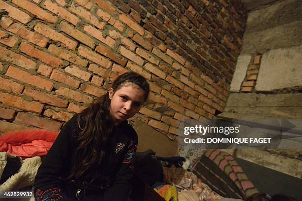 Ania, 11-years-old, sits waiting for the end of the shelling in Donetsk's Petrovski district, in the eastern Ukraine on February 4, 2015. Donetsk's...