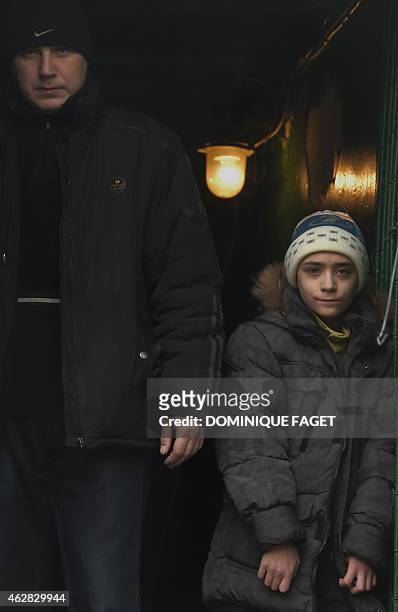 Artium,10-years-old, stands at the entrance of a bomb shelter in Donetsk's Kiyevski district, in the eastern Ukraine on February 5, 2015. Donetsk's...