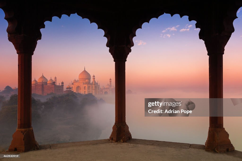 Taj Mahal in fog framed by arches