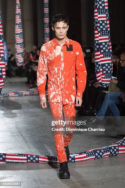Model walks the runway during the Raf Simons/Sterling Ruby Menswear Fall/Winter 2014-2015 show as part of Paris Fashion Week>> on January 15, 2014 in...