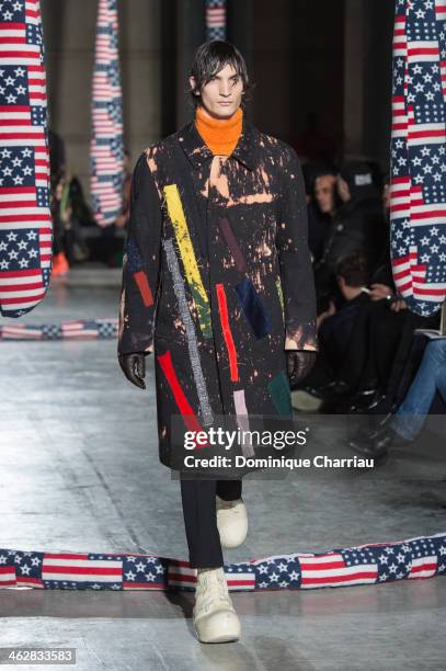 Model walks the runway during the Raf Simons/Sterling Ruby Menswear Fall/Winter 2014-2015 show as part of Paris Fashion Week>> on January 15, 2014 in...