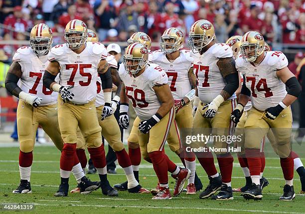 Anthony Davis, Alex Boone, Jonathan Goodwin, Mike Iupati, Joe Staley and Colin Kaepernick of the San Francisco 49ers run up to the line of scrimmage...