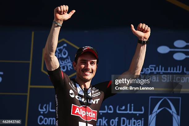 John Degenkob of Germany and Team Giant-Alpecin celebrates with team mate Luka Mezgec of Slovenia winning stage three of the Dubai Tour from the...