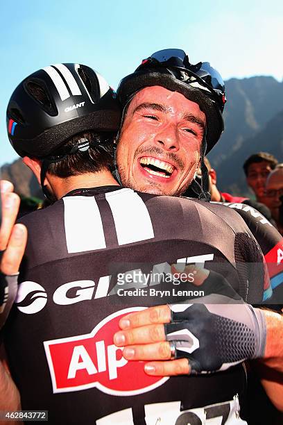 John Degenkob of Germany and Team Giant-Alpecin celebrates with team mate Luka Mezgec of Slovenia winning stage three of the Dubai Tour from the...
