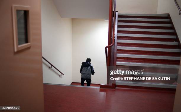 Pupil walks in the stairs at Pierre de Ronsard primary school on February 6, 2015 in Paris. AFP PHOTO / STEPHANE DE SAKUTIN