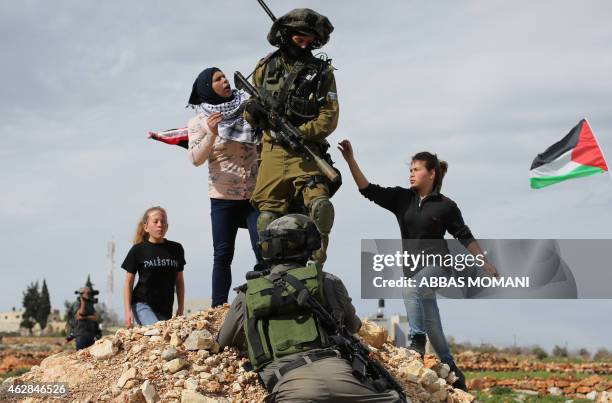 Palestinian Ahed Tamimi and her mother Nariman scuffle with Israeli security forces during clashes following a demonstration in the West Bank village...