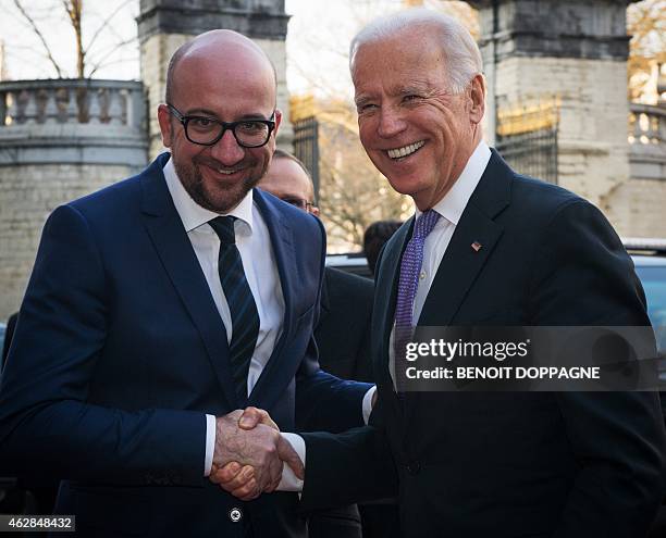 Belgian Prime Minister Charles Michel welcomes US Vice-President Joe Biden before their a meeting at the Egmont Palace in Brussels on February 6,...